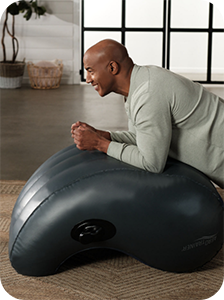 Mature man using the AeroTrainer to perform a more comfortable plank
